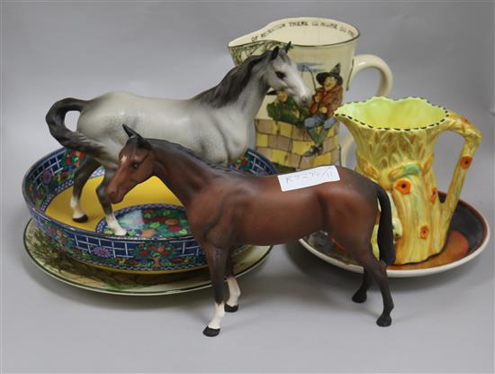 A group of assorted ceramics including two Beswick horses, a Doulton anglers jug and a Poole dish